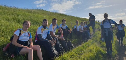 A group of hikers sat on a hill.
