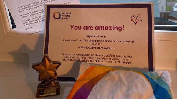 A photo of a letter, certificate, trophy and t-shirt. On the certificate are the words, 'You are amazing!'